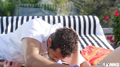 A stunning curvy MILF shows off her riding skills in the sun during an intense poolside session